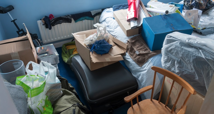 Bedroom with bags, boxes, and personal items ready for Ferndale cleanup planning